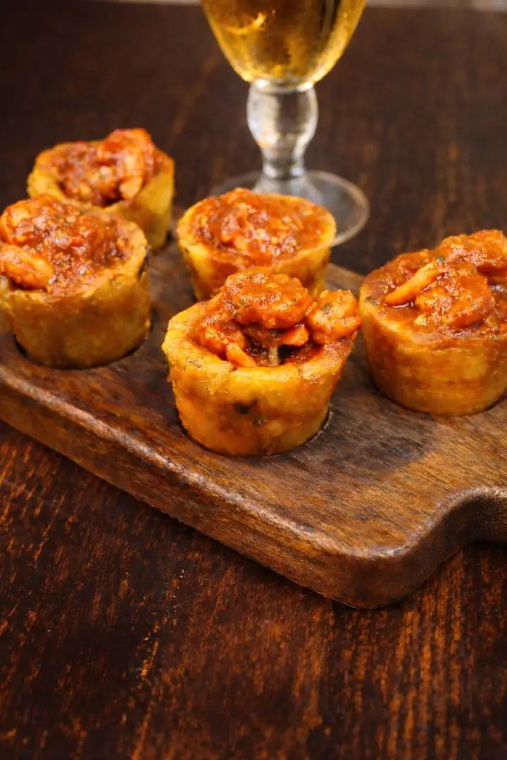 Tostones rellenos de camarón en salsa criolla